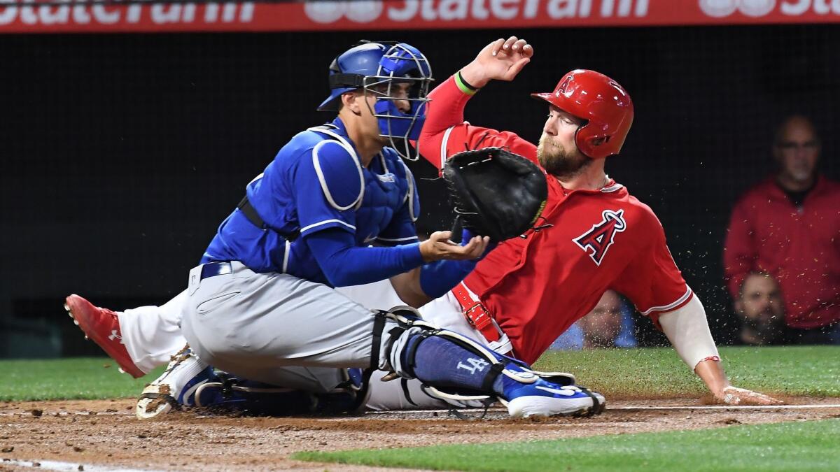 Angels' Kevan Smith beats the tag of Dodgers catcher Austin Barnes to score during the second inning of Monday's Freeway Series game.