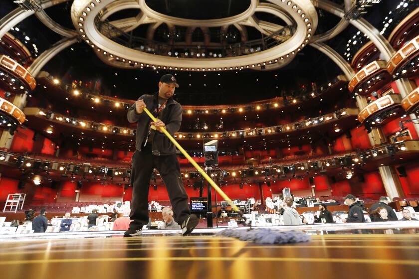 HOLLYWOOD, CA - FEBRUARY 22, 2019 Christian Rosso makes a clean sweep on stage in the Dolby Theatre during Friday rehearsals as preparations continue for the 91st Oscars show this coming Sunday. (Al Seib / Los Angeles Times)