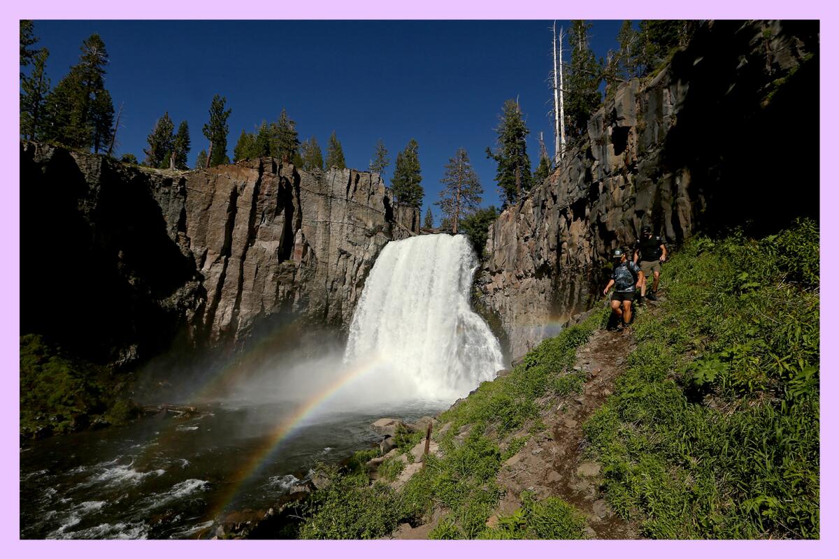 Hikers follow a trail to the right of Rainbow Falls.