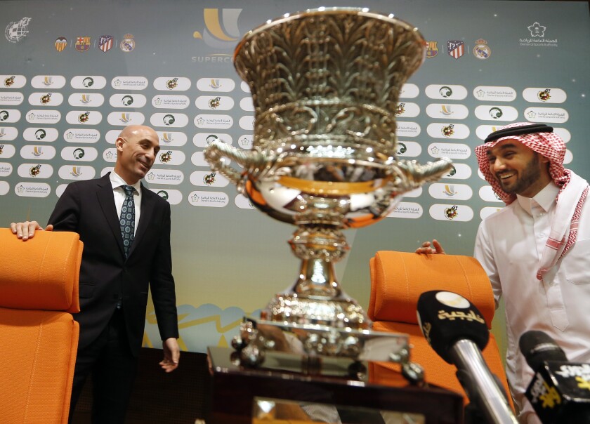 FILE - President of the Spanish Soccer Federation, Luis Rubiales, left, and Saudi General Sport Authority GSA chairman Prince Abdulaziz bin Turki Al-Faisal enter a press conference behind the Spanish Super Cup in Jiddah Saudi Arabia, Wednesday, Dec. 18, 2019. Facing criticism from human rights groups and concerned Spanish media, the president of Spain’s soccer federation defended the return of Spanish Super Cup to Saudi Arabia while Real Madrid prepares to face Athletic Bilbao in the final. Amnesty International had asked the four teams that travelled to play in the mini-tournament to wear armbands in protest of the regime’s suppression of women’s rights and attacks on persons of the LGBTQ community. (AP Photo/Amr Nabil, File)