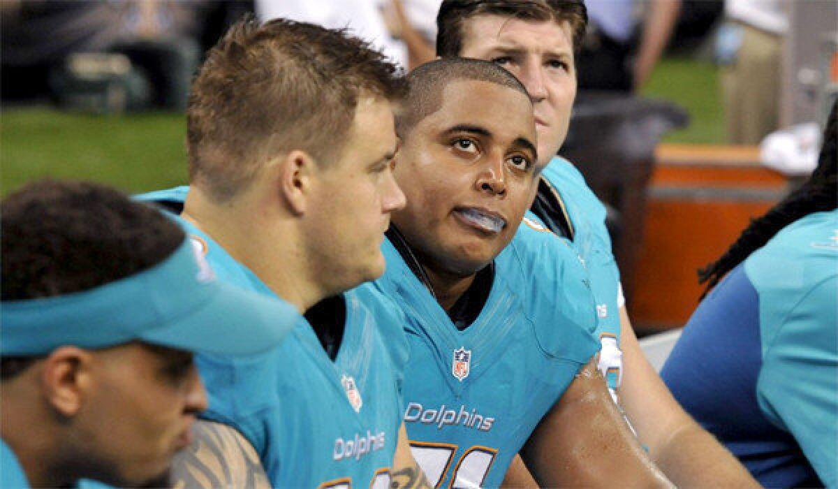 Offensive linemen Richie Incognito, left, and Jonathan Martin, right, on the sidelines during Miami's 38-17 loss to New Orleans on Sept. 30.