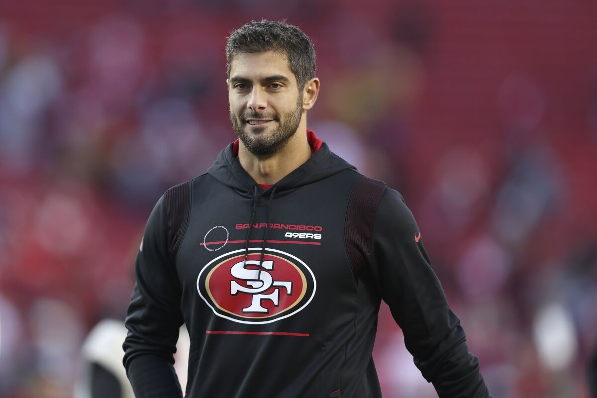 Injured San Francisco 49ers quarterback Jimmy Garoppolo walks off the field after the 49ers defeated the Houston Texans in an NFL football game in Santa Clara, Calif., Sunday, Jan. 2, 2022. (AP Photo/Jed Jacobsohn)
