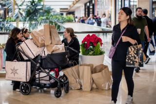 COSTA MESA, CA - NOVEMBER 25, 2022: The Naybe family,left, of Irvine takes a break after a shopping spree on Black Friday at South Coast Plaza on November 25, 2022 in Costa Mesa, California.(Gina Ferazzi / Los Angeles Times)
