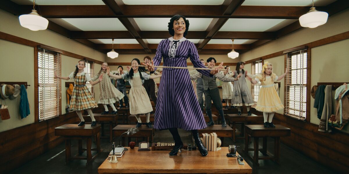 A woman and chorus dancing on tables.