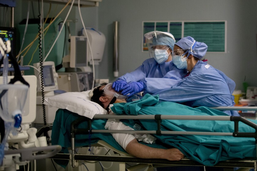 Medical staff tend to a patient in the emergency COVID-19 ward at a hospital in Milan, Italy.