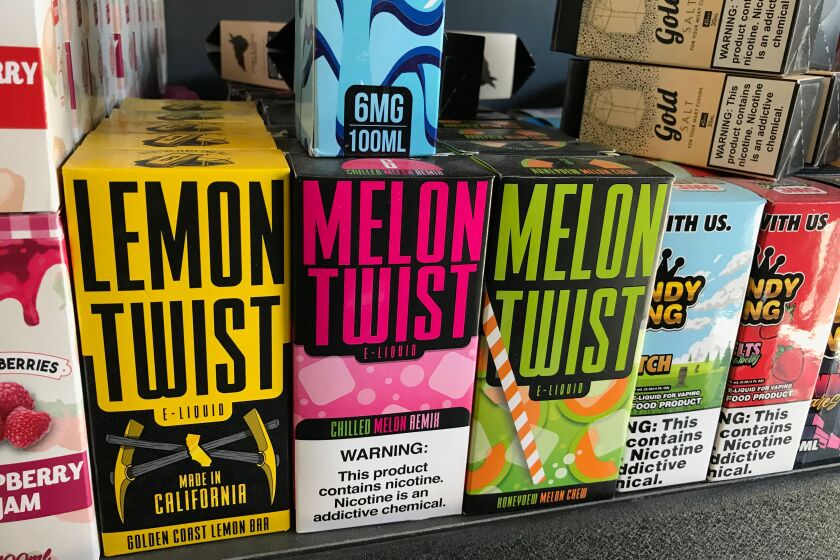 Flavored vaping products containing nicotine are seen in a store in Los Angeles, California, September 17, 2019. - New York became the second US state to ban flavored e-cigarettes Tuesday, following several deaths linked to vaping that have raised fears about a product long promoted as less harmful than smoking. (Photo by Robyn Beck / AFP) (Photo credit should read ROBYN BECK/AFP/Getty Images)
