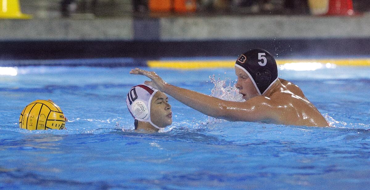 Huntington Beach's Chase Dodd, right, defends against Harvard-Westlake's Ethan Shipman in the CIF Southern Section Division 1 semifinal playoff match at Woollett Aquatics Center in Irvine on Wednesday.