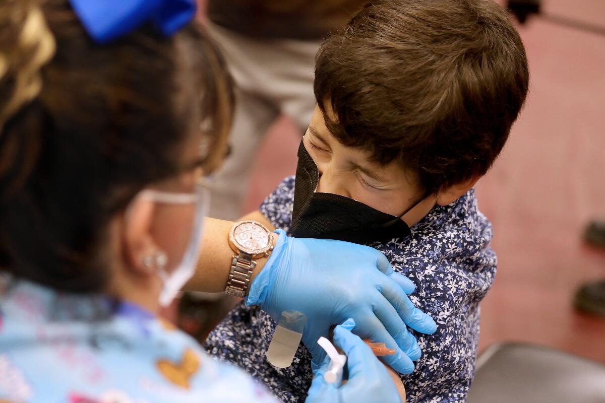 Luxiano Gonzalez, 8, of El Monte, receives a COVID-19 vaccination at Eugene A. Obregon Park.