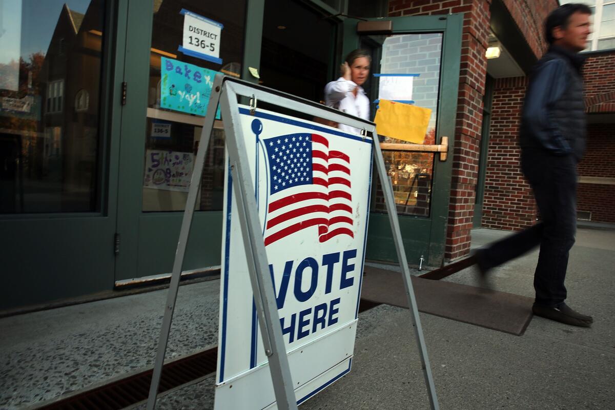 Voters exit a polling station in Westport, Conn., on Nov. 4