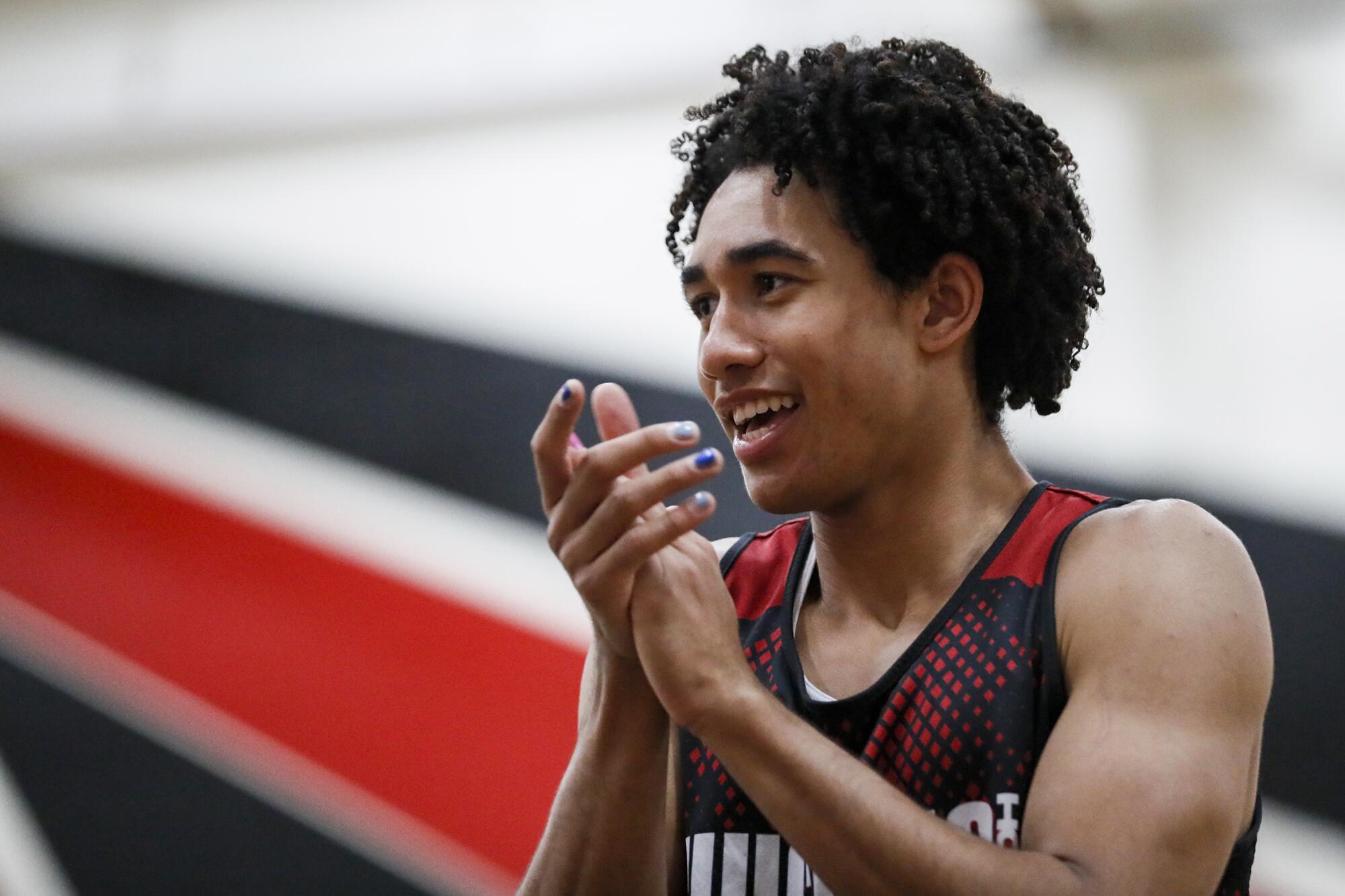 Centennial High guard Jared McCain claps his hand during practice.