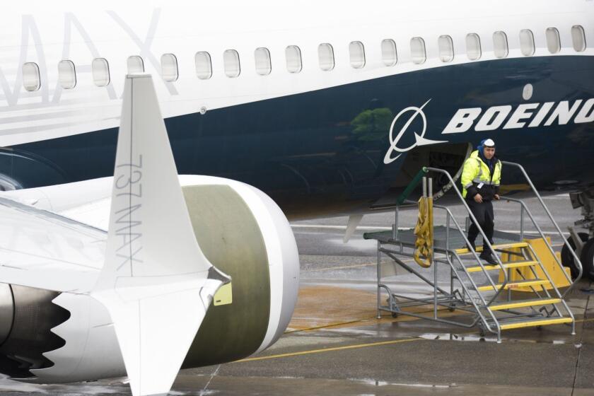 (FILES) In this file photo taken on March 12, 2019 A worker is pictured next to a Boeing 737 MAX 9 airplane on the tarmac at the Boeing Renton Factory in Renton, Washington. - US Transportation Secretary Elaine Chao on March 19, 2019 formally directed an internal watchdog office to audit the certification process for Boeing's 737 MAX 8 aircraft following recent deadly crashes. Chao's request comes amid reports US authorities have also launched a criminal probe into the certification of the top-selling jet, which has been grounded around the world. (Photo by Jason Redmond / AFP)JASON REDMOND/AFP/Getty Images ** OUTS - ELSENT, FPG, CM - OUTS * NM, PH, VA if sourced by CT, LA or MoD **