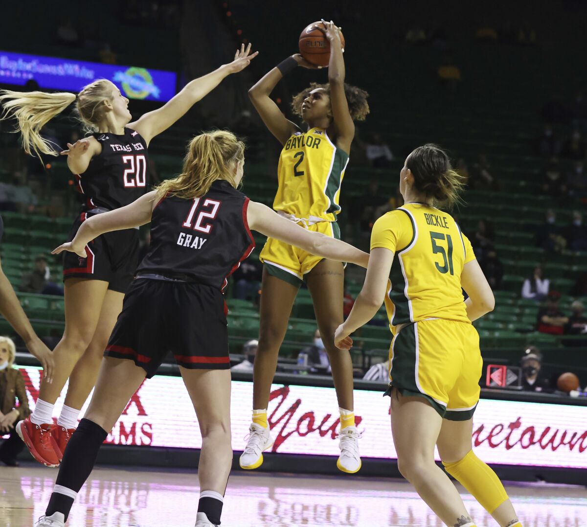 Baylor guard DiDi Richards, center, looks to the basket while shooting against Texas Tech forward Bryn Gerlich , left, in the second half of an NCAA college basketball game, Monday, Dec. 14, 2020, in Waco, Texas. (Rod Aydelotte/Waco Tribune-Herald via AP)