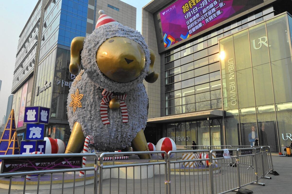 A giant ram or sheep statue stands outside a shopping center in Beijing. China will usher in the year of the sheep on Feb. 19.