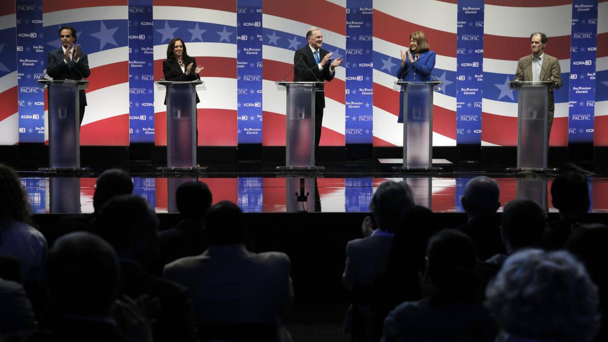 Senate candidates Tom Del Beccaro, Kamala Harris, George Duf Sundheim, Loretta Sanchez and Ron Unz stand on the debate stage at the University of the Pacific in Stockton, Calif. on April 25.