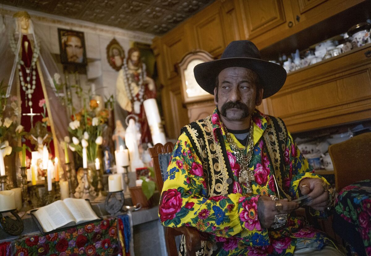 Zoltan Sztojka, traditional Gypsy fortune-teller is seen in his home in Soltvadkert, central Hungary on Oct. 10, 2021. Sztojka, by his own account Hungary’s last Roma fortuneteller, is working to preserve his culture's traditions that are slowly vanishing in the Central European country. (AP Photo/Bela Szandelszky)