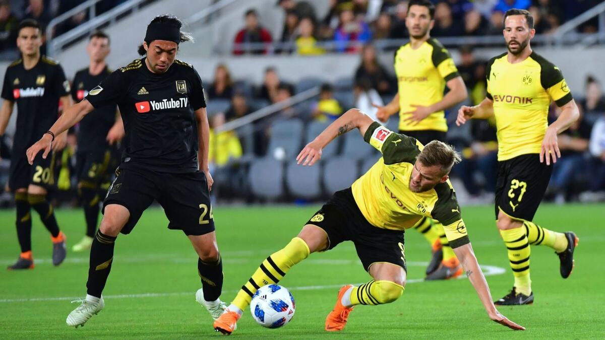 Borussia Dortmund's Andrey Yarmolenko, right, vies for the ball with LAFC's Lee Nguyen during their international soccer friendly on Tuesday.