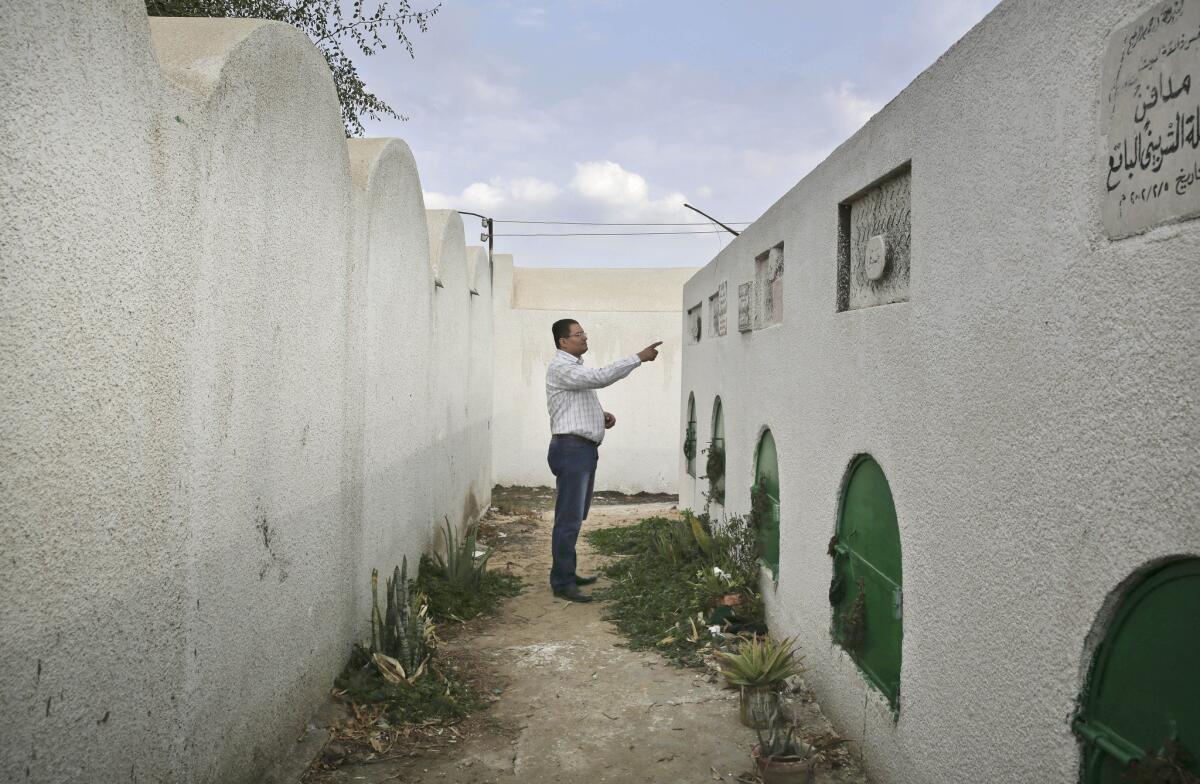 Egyptian lawyer Reda Danbouki points to the crypt of Soheir Bataa, 13, in the village of Dierb Biqtaris, in a photo taken Nov. 5. Soheir died after undergoing genital excision.