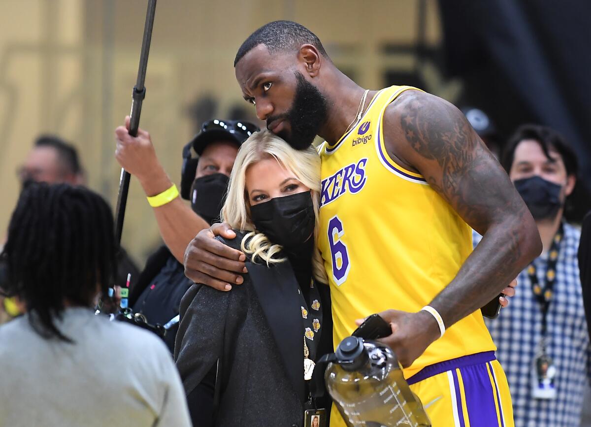 Lakers star LeBron James hugs owner Jeanie Buss.