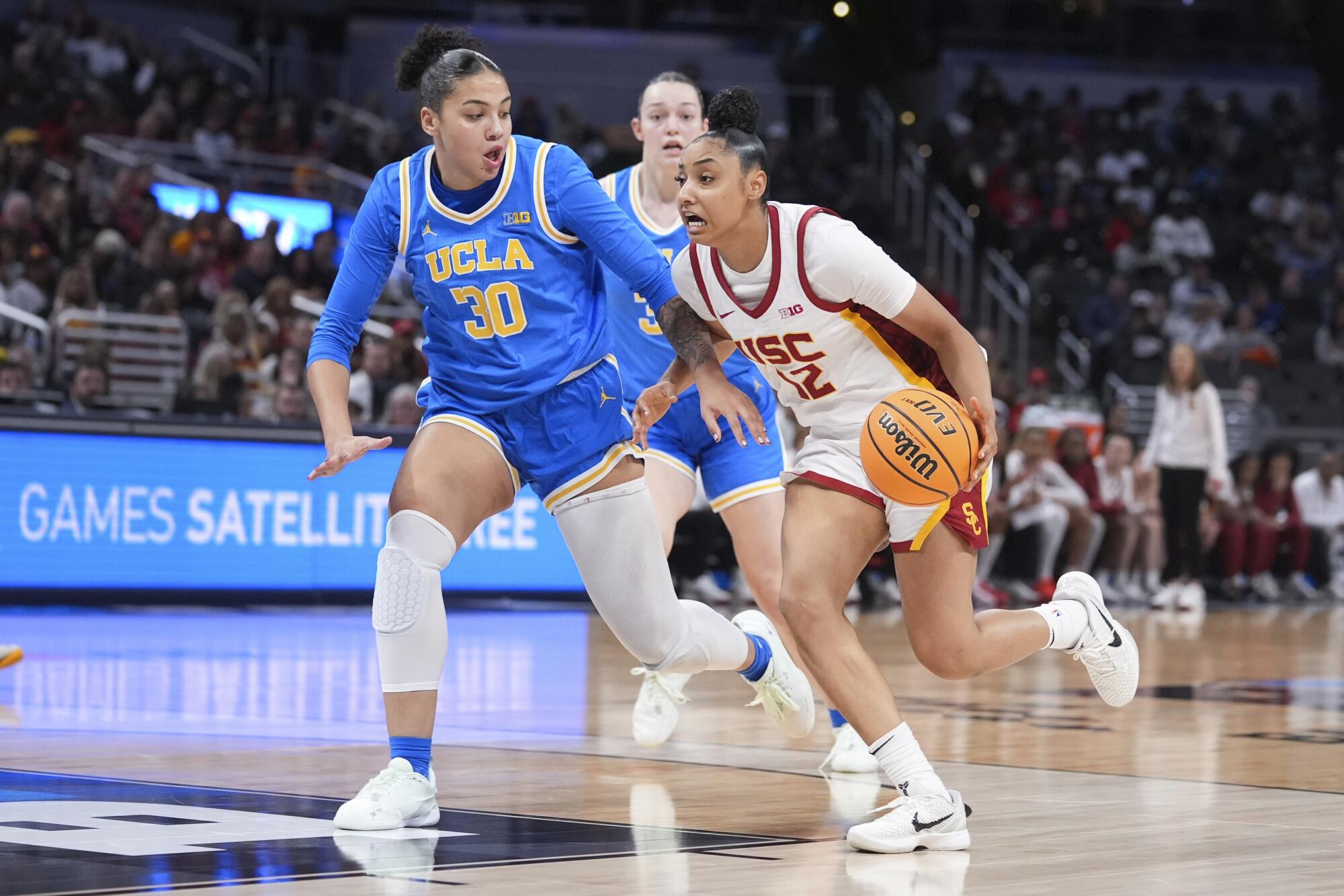 UCLA girls get revenge, rallying to defeat USC for Massive Ten event title 2 USC guard JuJu Watkins, right, drives on UCLA forward Timea Gardiner during the first half Sunday.