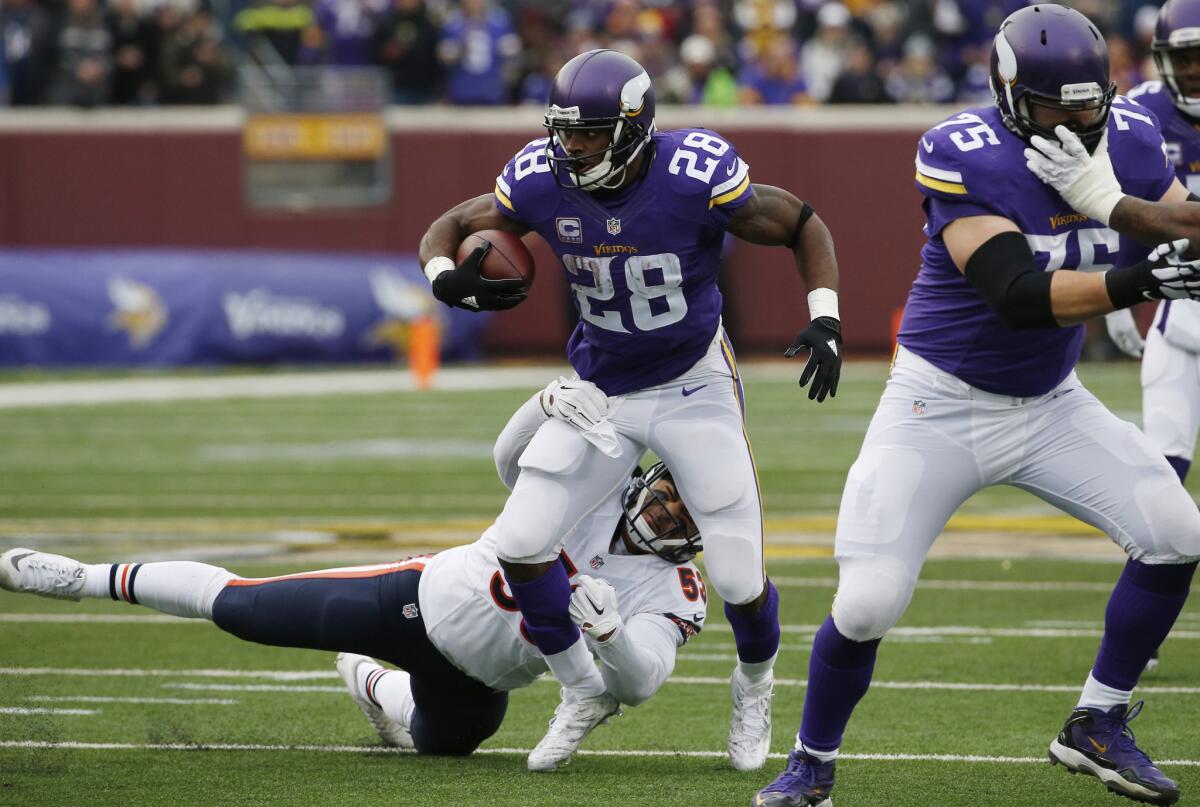 Bears linebacker John Timu tries to tackle Vikings running back Adrian Peterson (28) during the first half.