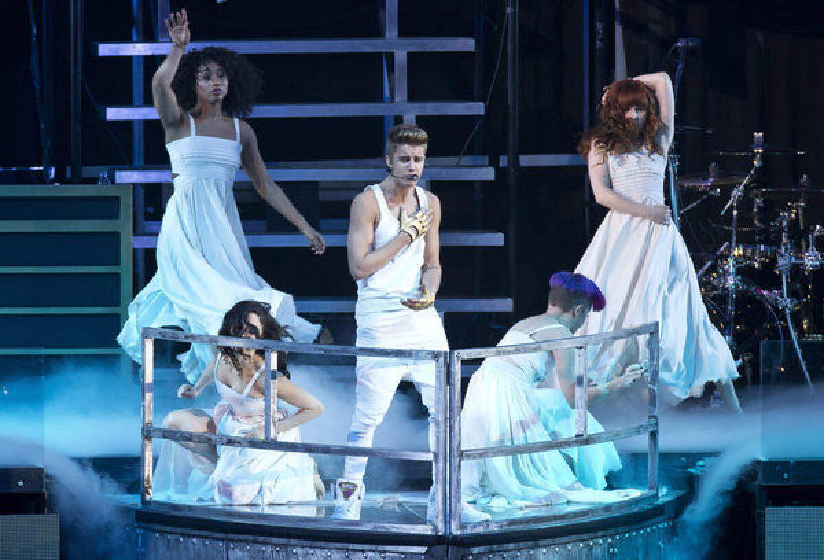 Justin Bieber performs in London on Monday. He collapsed offstage during Thursday's show and was treated for breathing problems, but finished the last four songs of his program before heading to the hospital.