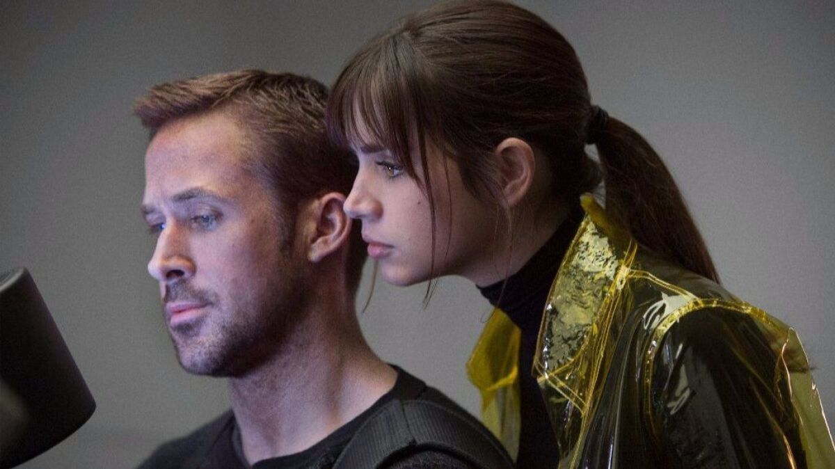 Ryan Gosling, left, as K and Ana de Armas as Joi in the action thriller "Blade Runner 2049."