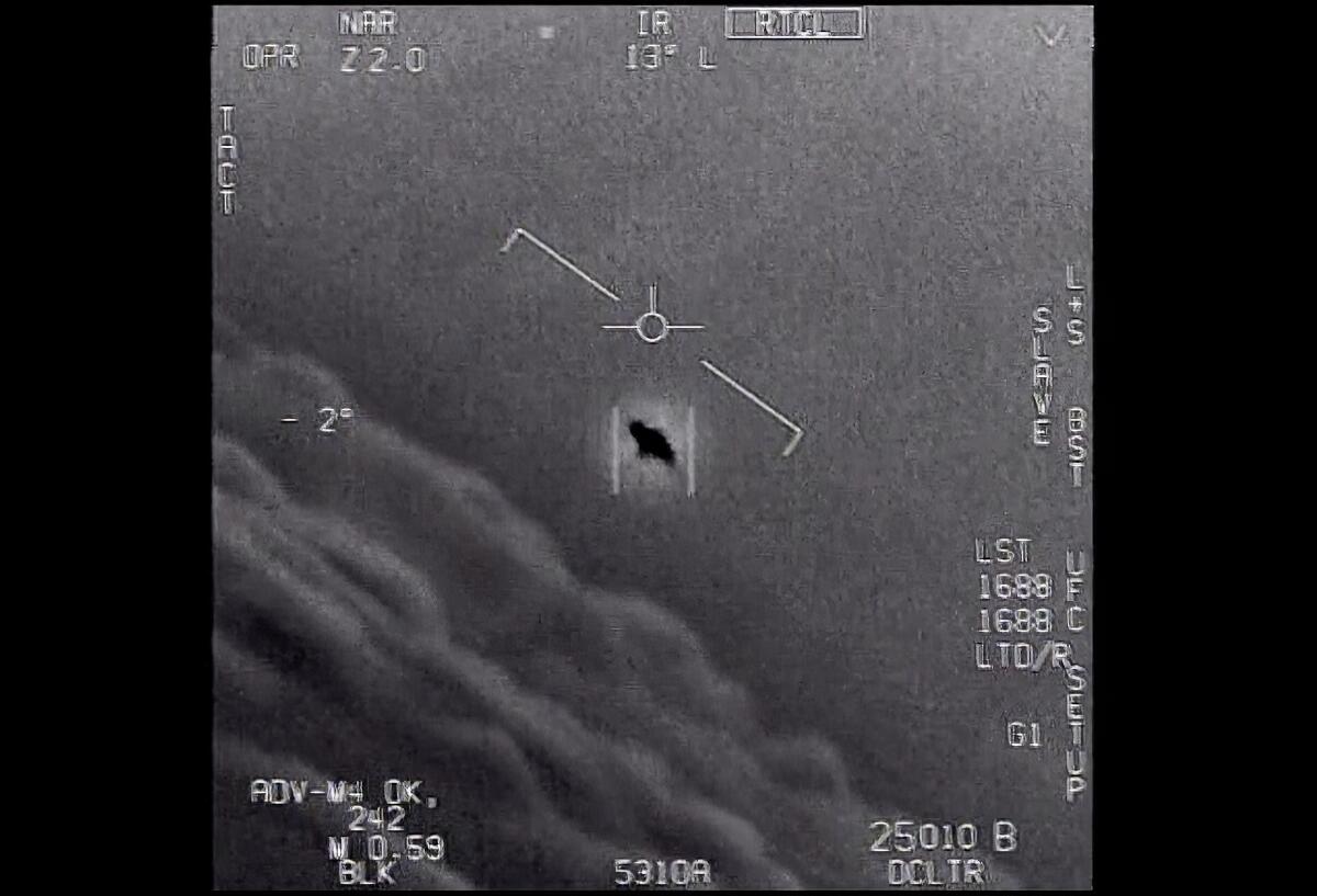 an unexplained object is seen at center as it is tracked as it soars high along the clouds, traveling against the wind.