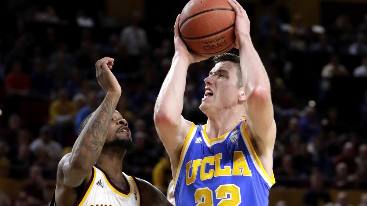 UCLA forward TJ Leaf trie to power his way past Arizona State guard Torian Graham for a layup during the first half Thursday night.