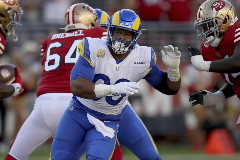 Los Angeles Rams defensive tackle Aaron Donald (99) fights off a blocker during an NFL football game.