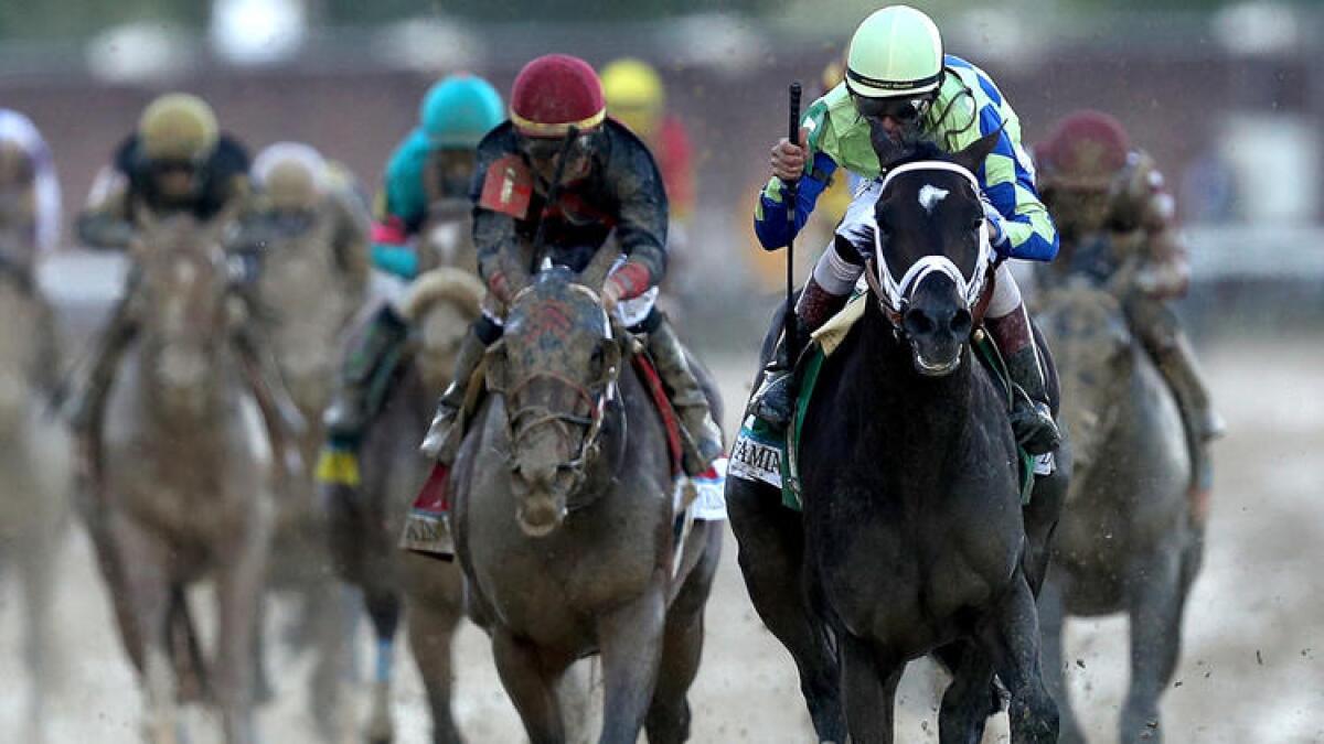 Jockey John Velazquez celebrates as he guides Always Dreaming across the finish line to win the 143rd running of the Kentucky Derby on Saturday at Churchill Downs.