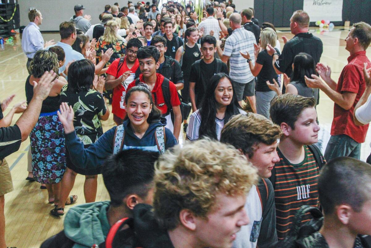 Incoming freshman at Westview High School in San Diego pass through a “Welcome Tunnel” greeting faculty and staff on the first day of school.
