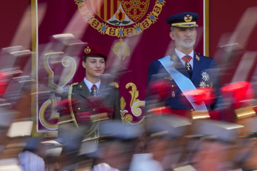 FILE - Spain's Princess Leonor, left, and King Felipe VI attend the military parade on the national holiday known as "Dia de la Hispanidad" or Hispanic Day, in Madrid, Spain, Thursday, Oct. 12, 2023. Spain’s heir to the throne, Princess Leonor, is scheduled to swear allegiance to the nation's Constitution on turning 18 years old on Tuesday, Oct. 31, 2023, in a gala event that will make her eligible to be queen one day. (AP Photo/Manu Fernandez, File)