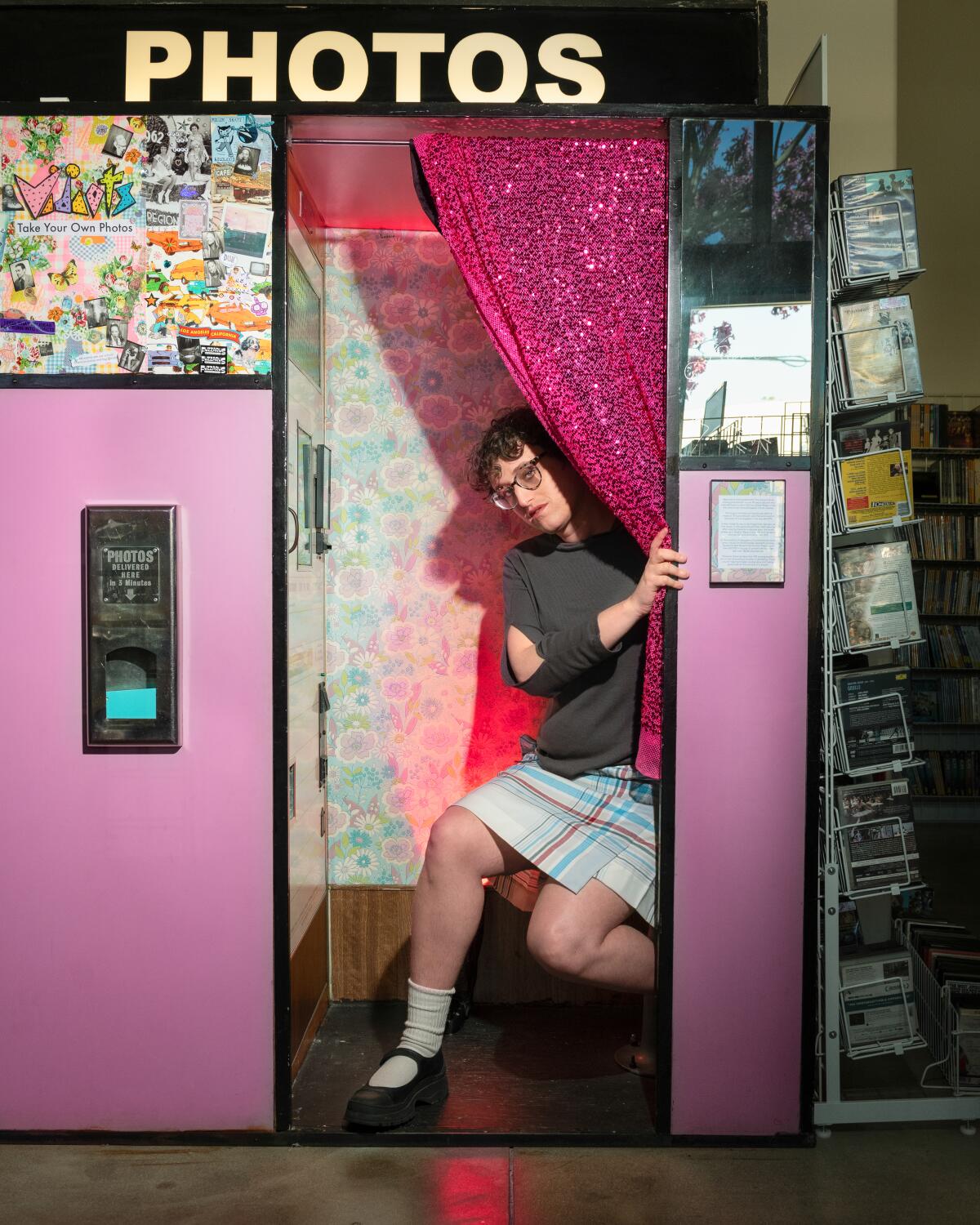 A filmmaker poses in a photo booth.