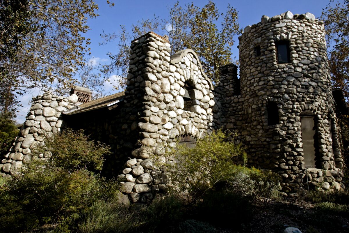 A home made of stone, with a round tower