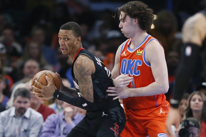 Houston Rockets forward Jabari Smith Jr., left, is defended by Oklahoma City Thunder guard Josh Giddey during the first half of an NBA basketball game Wednesday, March 27, 2024, in Oklahoma City. (AP Photo/Nate Billings)