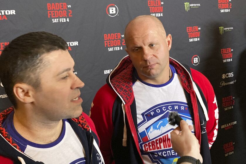 Fedor Emelianenko, rights, listens to interpreter Georgiy Litvinov during an interview in Los Angeles on Wednesday, Feb. 1, 2023. Emelianenko says he is ending his trailblazing mixed martial arts career after he fights Ryan Bader for the Bellator heavyweight title on Saturday, Feb. 4. (AP Photo/Greg Beacham)