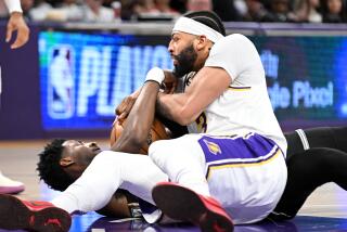 Los Angeles, California April 22, 2023-Lakers Anthony Davis battles or a loose ball with Grizzlies Jaren Jackson Jr.