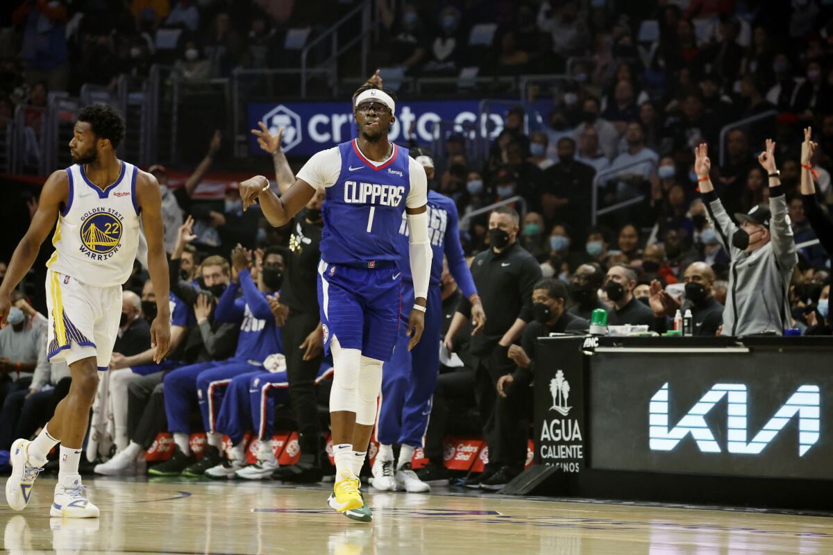 Clippers guard Reggie Jackson reacts as does the crowd after he hit a three-pointer against the Golden State Warriors.