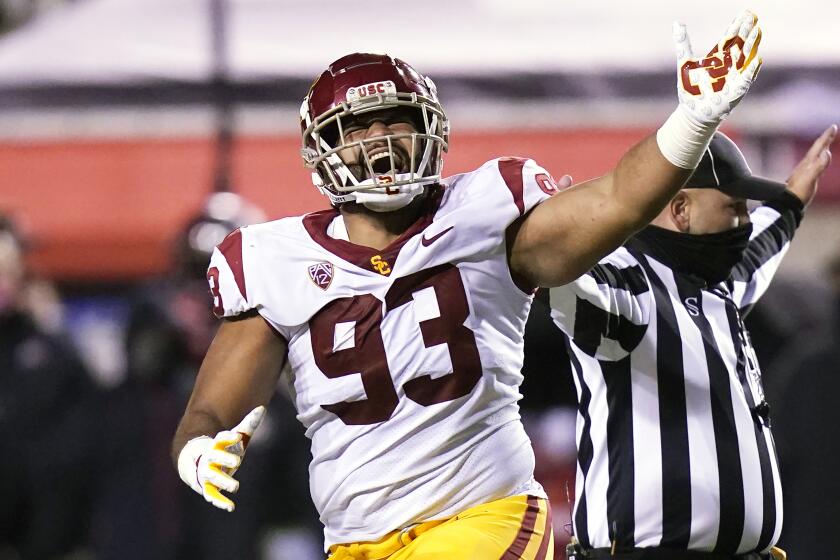 Southern California defensive lineman Marlon Tuipulotu (93) celebrates after fumble recovery.
