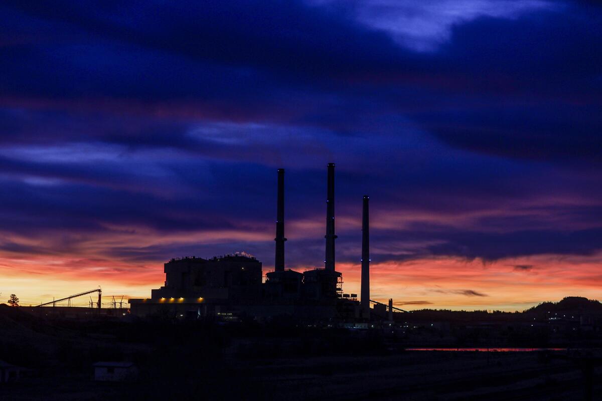 A Montana power plant is seen against the backdrop of a twilight sky.
