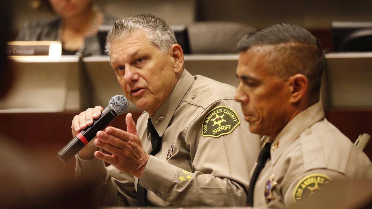 L.A. County Sheriff's Chief John Benedict, left, and Capt. Robert Lewis address the Sheriff Civilian Oversight Commission to discuss concerns of racial profiling by a highway enforcement team on the 5 Freeway.