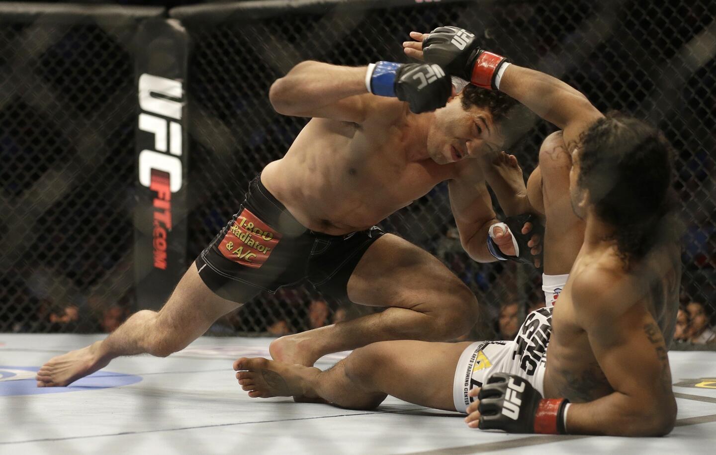 Gilbert Melendez tries to gain the upper hand with Benson Henderson on the mat during the first round of their UFC lightweight championship fight on Saturday night in San Jose.