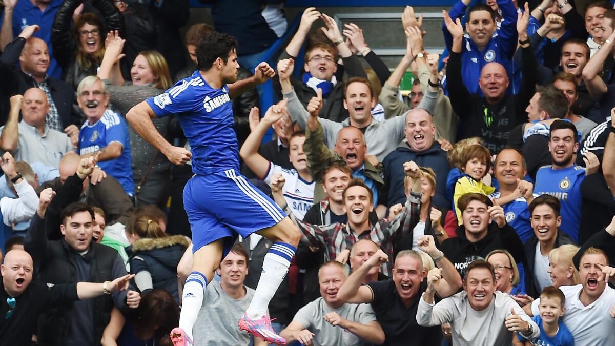 Chelsea's Diego Costa celebrates in front of the team's jubilant fans after scoring a goal against Arsenal on Oct. 5.