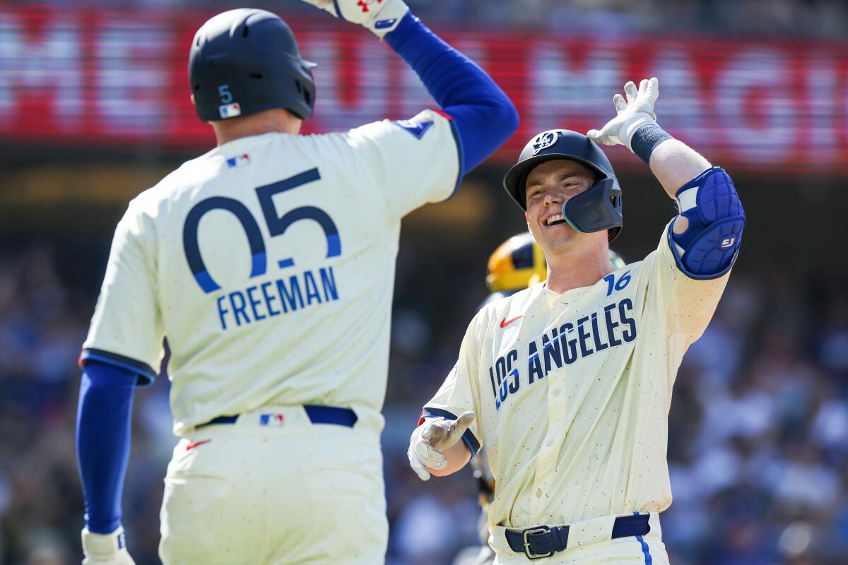 Will Smith, right, celebrates with Freddie Freeman after hitting a two-run home run in the first inning Saturday.