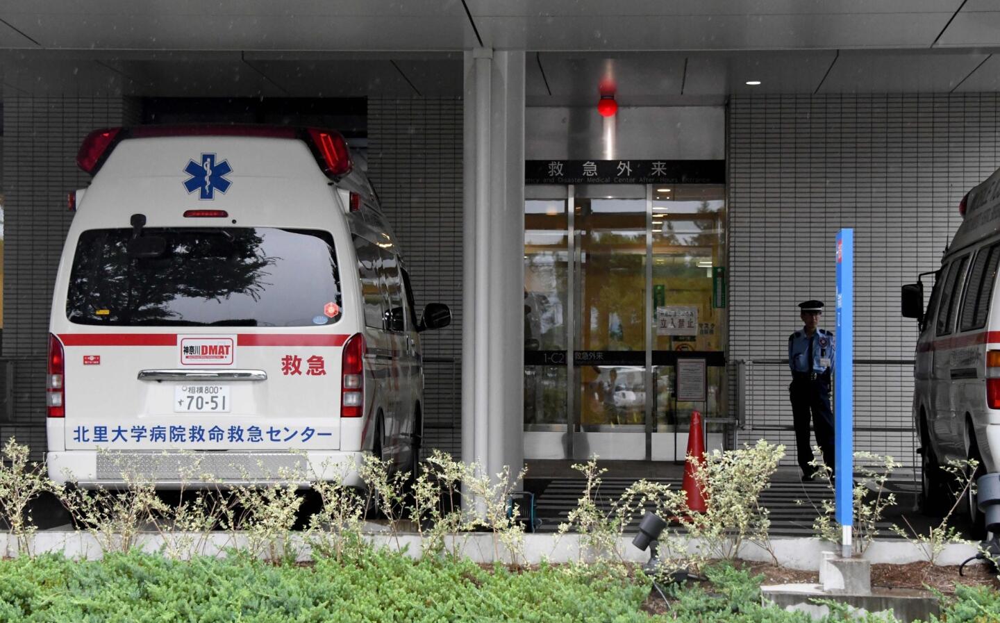 Ambulances wait at the entrance of Kitasato University hospital after more than a dozen injured people were brought after an attack at a residential-care facility.