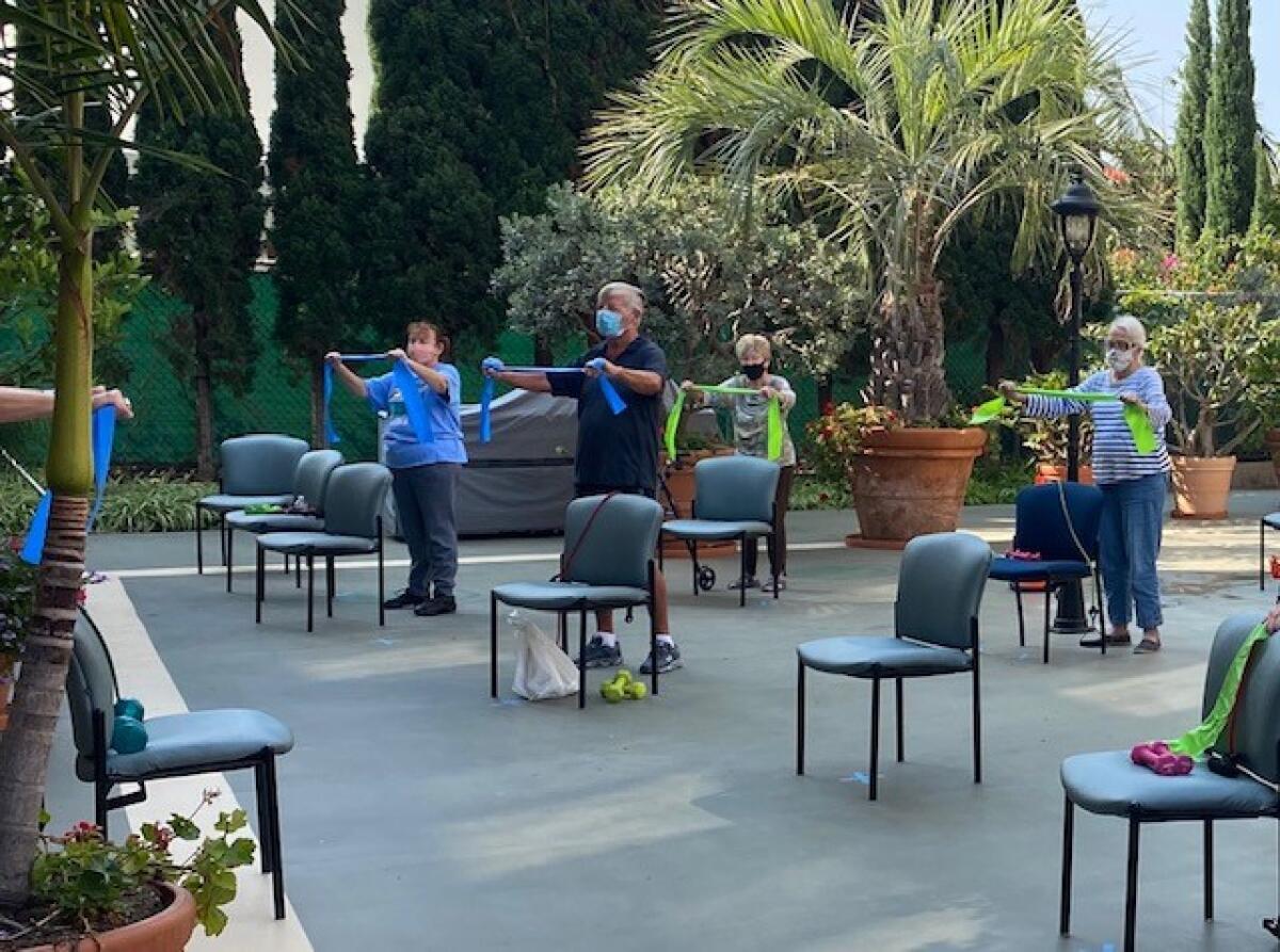 Chateau La Jolla residents participate in an outdoor exercise class.