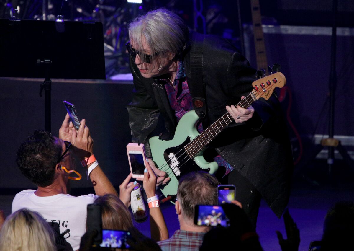 Psychedelic Furs bassist Tim Butler leans close to fans.