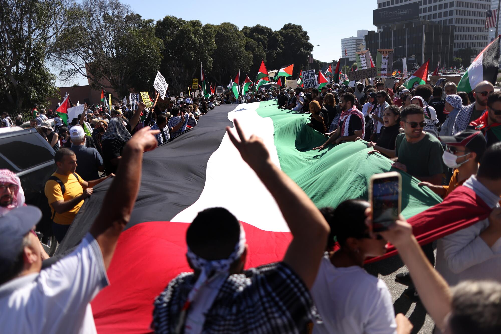 Hundreds of people gather and march in Westwood in support of Palestinians caught in the Israel-Hamas war.