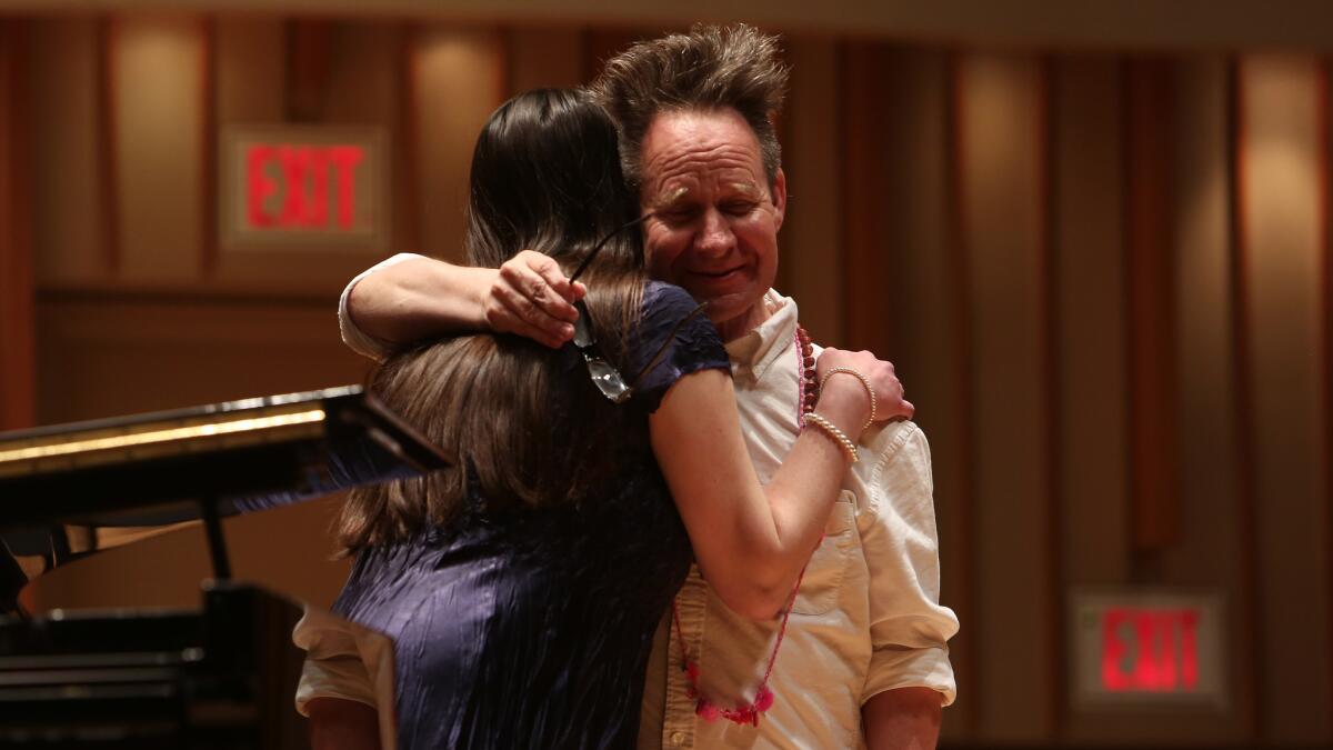 Peter Sellars gives Kate Johnson a hug after she sang "If Music Be the Food of Love" during a master class at Songfest at the Colburn School.