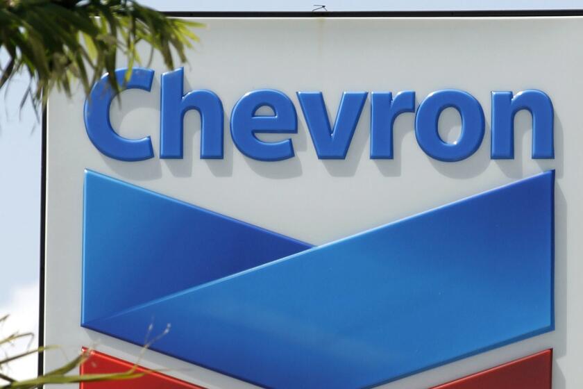 FILE- This Aug. 20, 2012, file photo, shows a Chevron sign in Miami. A Northern California jury ordered Chevron Corp. to pay the families of two brothers a combined $21.4 million after they claimed the men's exposure to a toxic chemical while working at a company plant caused the cancer that killed them. The San Francisco Chronicle reported that The Contra Costa County jury's verdict Friday, March 29, 2019. Brothers Gary Eaves and Randy Eaves worked at a Chevron-owned tire manufacturer in Arkansas. (AP Photo/Alan Diaz, File)
